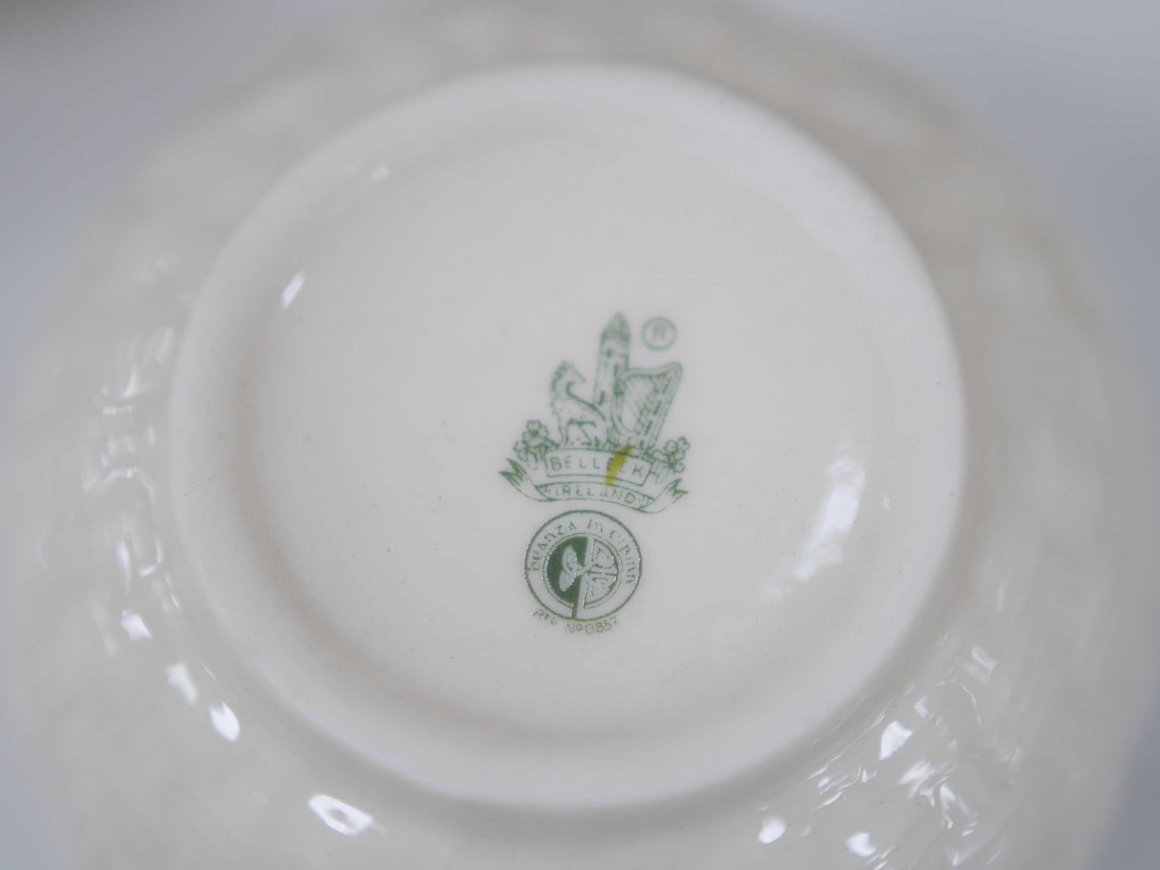 A Belleek serving plate, milk jug and two bowls and three Donegal vases, tallest item 25cm high. Condition - good